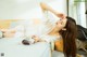 A woman laying on a bed in a white dress.