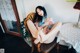 A woman sitting on a chair with her legs crossed.