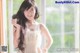 A woman in a white dress posing for a picture.